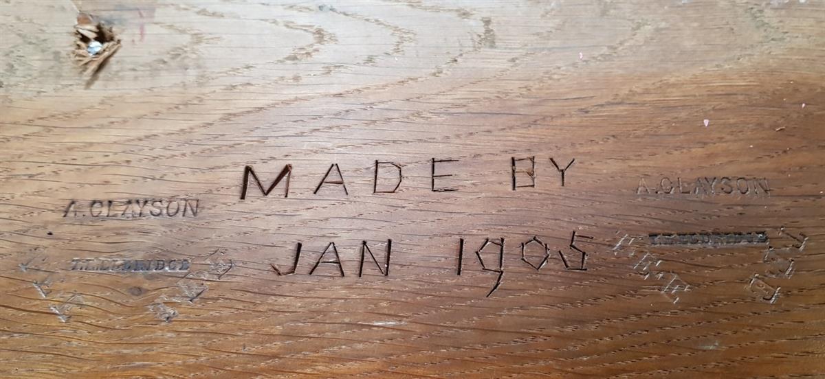 Maker's mark on the pew
